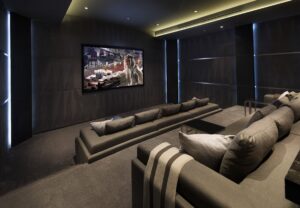 Home Cinema Seating on a Budget arrangement with comfortable gray sofas facing a large screen.